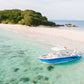 Keelooma's private speedboat Kandooma anchored in clear shallow water off an empty white sand beach in El Nido, Palawan