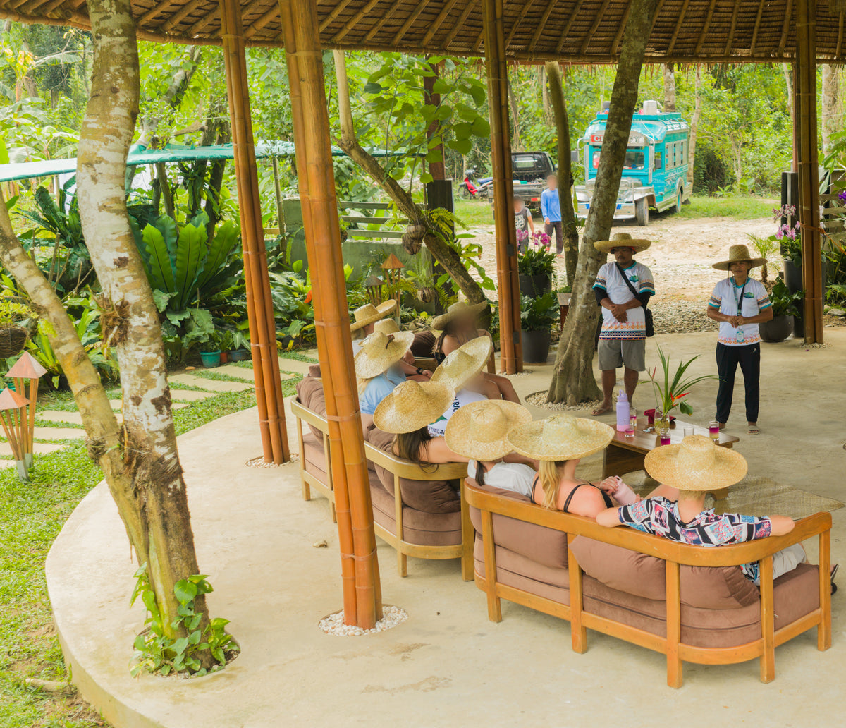 Guests in sombreros being briefed by Keelooma guides in the bamboo pavilion at Kaseledan Farm, with the jeepney waiting behind, El Nido, Palawan
