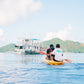Guests kayaking out to the Keelooma expedition boat anchored off an island on the Coron to El Nido route, Palawan