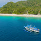 The Keelooma expedition boat, an outrigger banka, moored off Iloc Island in Linapacan, with a white-sand beach and coral reef on the El Nido to Coron route, Palawan