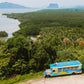 Keelooma's jeepney on a coastal ridge road above the mangroves at Sibaltan, El Nido, Palawan, with limestone cliffs on the horizon