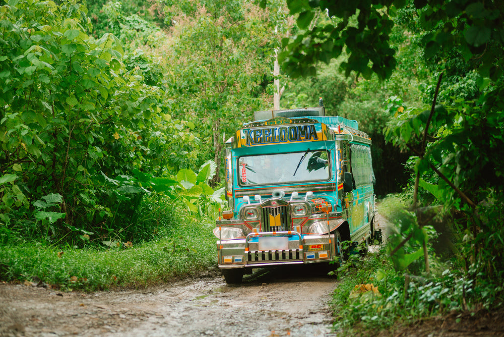 Keelooma's jeepney arriving along a jungle track at Kaseledan Farm in northern El Nido, Palawan