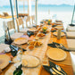A beachfront lunch table set for the Keelooma jeepney tour at Ursula Beach Club, with rice, lumpia and shared dishes facing the sea, Sibaltan, El Nido, Palawan